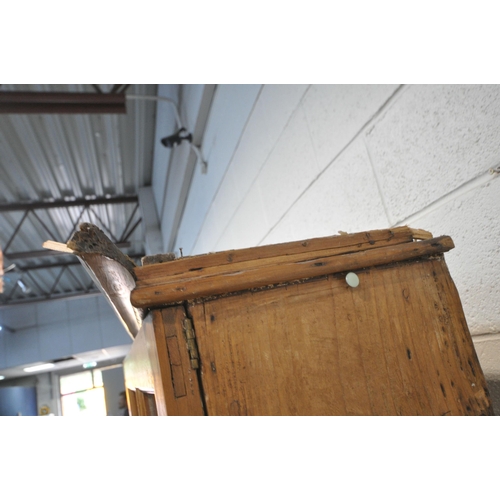 1261 - A 19TH CENTURY PINE BOOKCASE,  the two glazed doors enclosing an arrangement of shelving, above two ... 