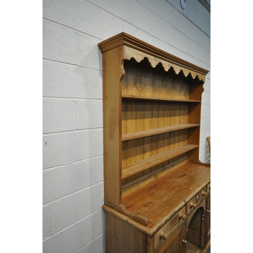 1263 - AN EARLY 20TH CENTURY PINE DRESSER, the three tier plate rack atop a base with three drawers, two cu... 