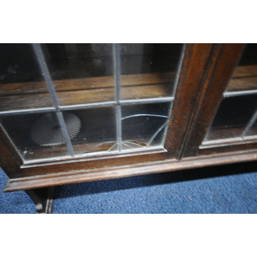 1288 - THREE 20TH CENTURY OAK BOOKCASES, two with lead glazed doors, one is a three tier waterfall open boo... 