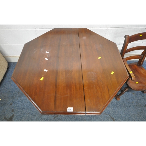 1293 - AN OCTAGONAL MAHOGANY CENTRE TABLE, raised on turned supports, ceramic castors, united by turned str... 