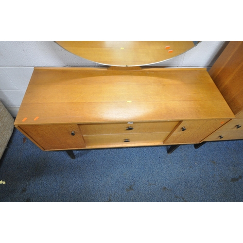 1300 - AUSTINSUITE, A MID CENTURY OAK TWO PIECE BEDROOM SUITE, comprising a dressing table, with an oval mi... 