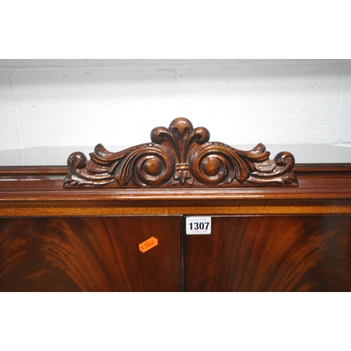 1307 - BRIDGECRAFT, A MAHOGANY COCKTAIL CABINET, with scrolled crest and apron, the top doors enclosing a m... 