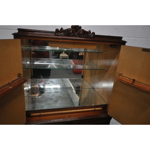 1307 - BRIDGECRAFT, A MAHOGANY COCKTAIL CABINET, with scrolled crest and apron, the top doors enclosing a m... 