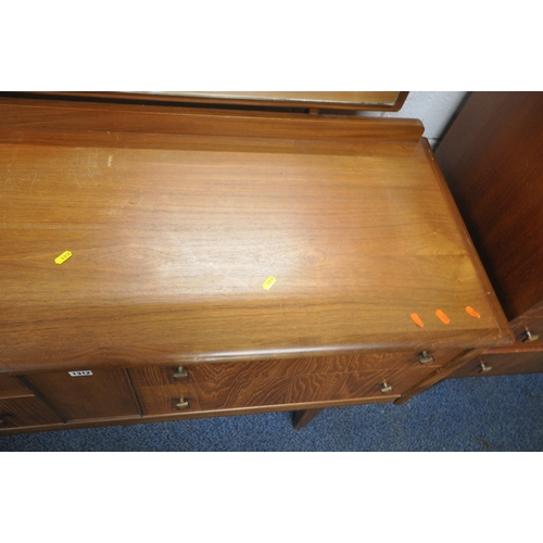 1312 - A MID CENTURY TEAK DRESSING TABLE, with a rectangular mirror, and four drawers, raised on square tap... 