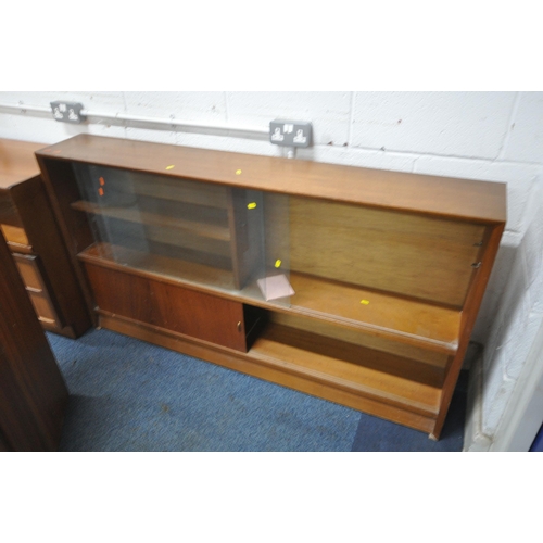 1318 - A SELECTION OF MID CENTURY TEAK FURNITURE, to include a bookcase with double glass sliding doors, ab... 