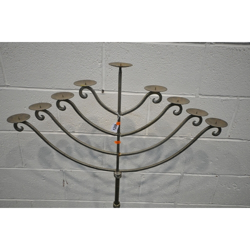 1328 - A WROUGHT IRON NINE BRANCH CANDELABRA, raised on three legs, height 144cm, along with a small three ... 