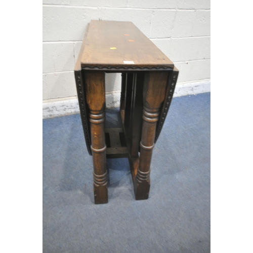 1330 - RUPERT GRIFFITHS, A 20TH CENTURY SOLID OAK OVAL GATE LEG TABLE, raised on block and turned legs, uni... 