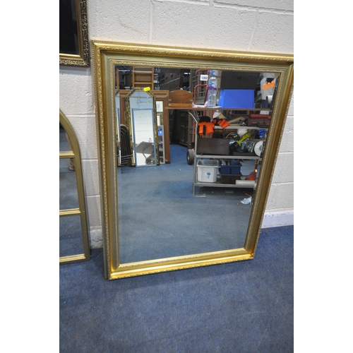 1352 - A LARGE GILT FRAME RECTANGULAR BEVELED EDGE WALL MIRROR, 118cm x 91cm, an arched mirror, a frameless... 