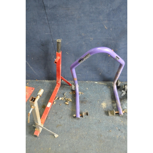 1059 - FOUR MOTORCYCLE PADDOCK STANDS including a front and back wheel by Micron, a frame mount by Bike wor... 