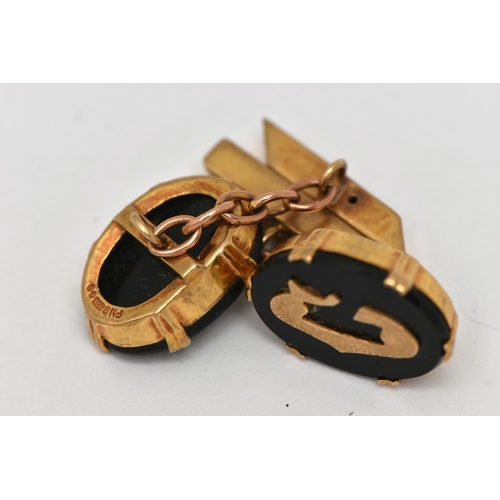 1 - A PAIR OF 9CT GOLD AND ONYX CUFFLINKS, each designed with an oval onyx panel in a double six claw se... 