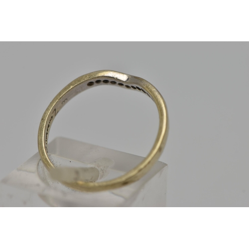 10 - A 9CT GOLD SHAPED DIAMOND BAND RING, eleven round brilliant cut diamonds, channel set in a shaped ba... 