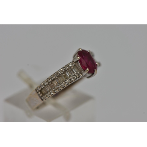 11 - A GEM SET RING, an oval cut ruby in a prong setting, flanked with baguette and round brilliant cut d... 