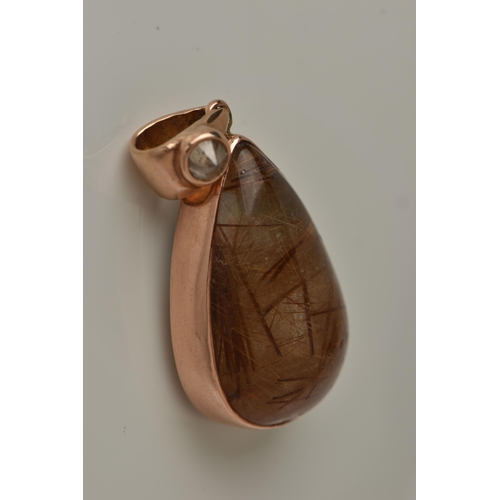 13 - A 9CT GOLD GEM SET PENDANT, a large teardrop rutilated quartz cabochon, collet set in rose gold, app... 