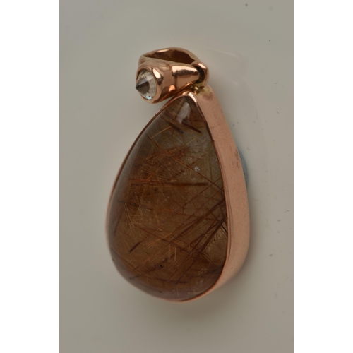 13 - A 9CT GOLD GEM SET PENDANT, a large teardrop rutilated quartz cabochon, collet set in rose gold, app... 