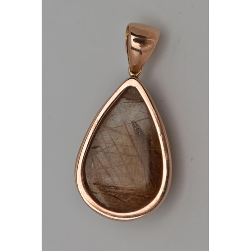 13 - A 9CT GOLD GEM SET PENDANT, a large teardrop rutilated quartz cabochon, collet set in rose gold, app... 