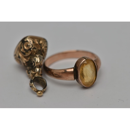 15 - TWO EARLY 20TH CENTURY JEWELLERY ITEMS, the first an oval cut citrine, collet set in rose metal, unm... 