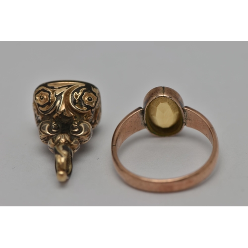 15 - TWO EARLY 20TH CENTURY JEWELLERY ITEMS, the first an oval cut citrine, collet set in rose metal, unm... 