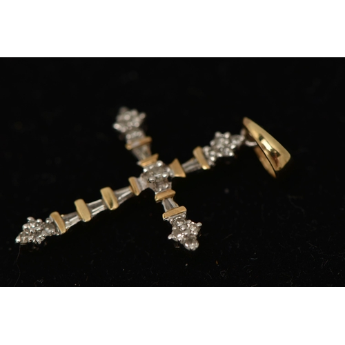 16 - A YELLOW METAL DIAMOND PENDANT, designed as a cross, set with round brilliant and tapered baguette d... 