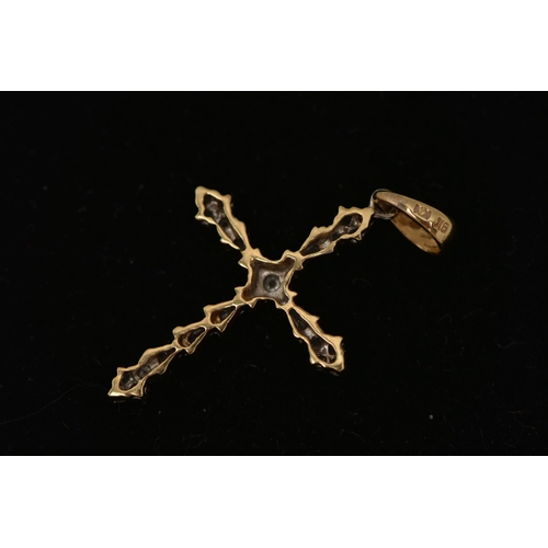 16 - A YELLOW METAL DIAMOND PENDANT, designed as a cross, set with round brilliant and tapered baguette d... 