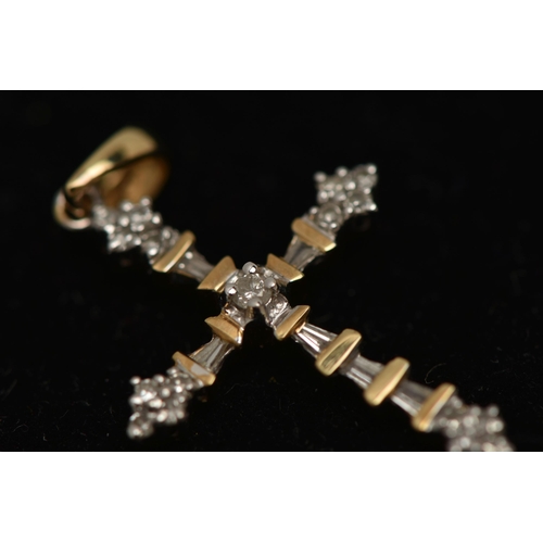 16 - A YELLOW METAL DIAMOND PENDANT, designed as a cross, set with round brilliant and tapered baguette d... 