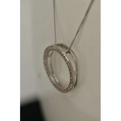 17 - A 9CT GOLD DIAMOND PENDANT, a circular form white gold pendant, grain set with round brilliant cut d... 