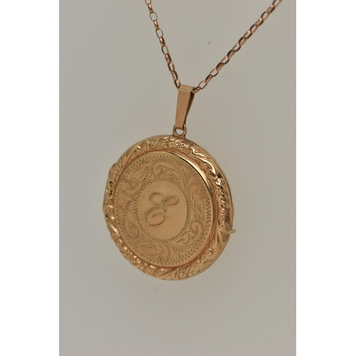 25 - A 9CT GOLD LOCKET PENDANT, a circular form pendant with scrolling detail, letter E engraving to the ... 