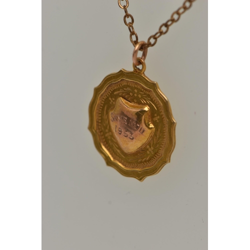 42 - A 9CT GOLD PENDANT WITH A CHAIN, a 9ct gold circular fob pendant with engraved shield cartouche read... 