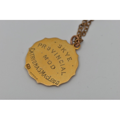 42 - A 9CT GOLD PENDANT WITH A CHAIN, a 9ct gold circular fob pendant with engraved shield cartouche read... 