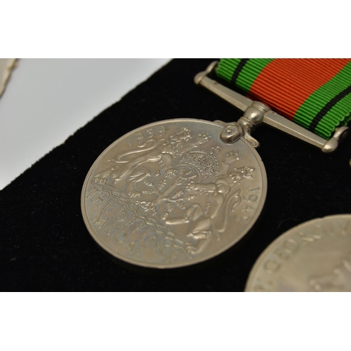 48 - THREE WW2 MEDALS, to include two Defense Medals with ribbons and a 1939-1945 war medal with ribbon