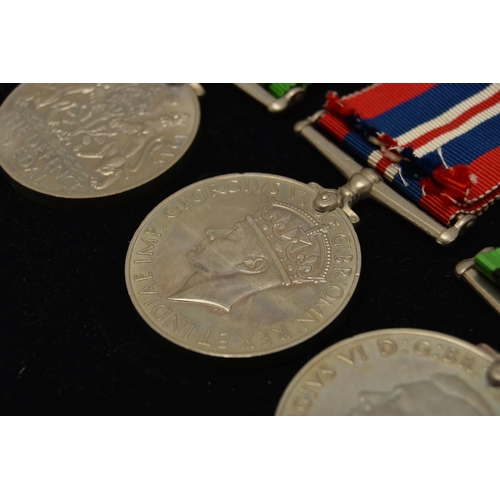 48 - THREE WW2 MEDALS, to include two Defense Medals with ribbons and a 1939-1945 war medal with ribbon