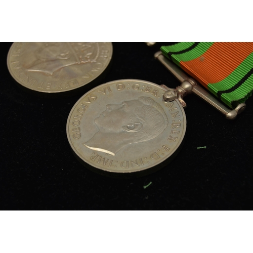 48 - THREE WW2 MEDALS, to include two Defense Medals with ribbons and a 1939-1945 war medal with ribbon