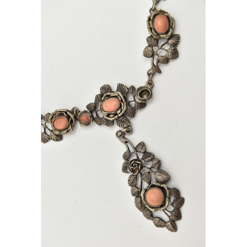 69 - A WHITE METAL NECKLACE, of a floral design set with worn coral cabochons (one is missing), fancy lin... 