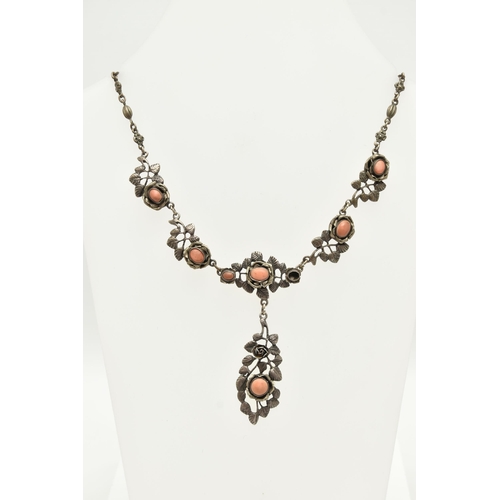 69 - A WHITE METAL NECKLACE, of a floral design set with worn coral cabochons (one is missing), fancy lin... 