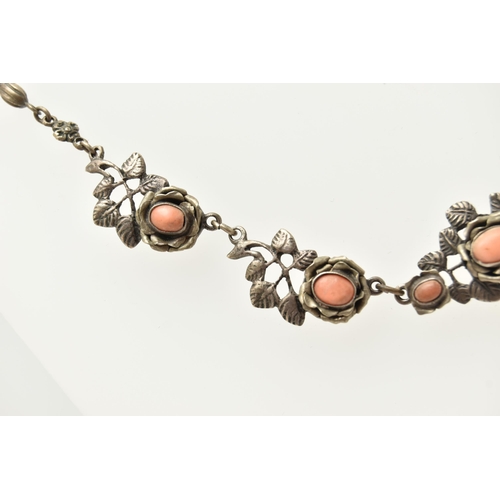 69 - A WHITE METAL NECKLACE, of a floral design set with worn coral cabochons (one is missing), fancy lin... 