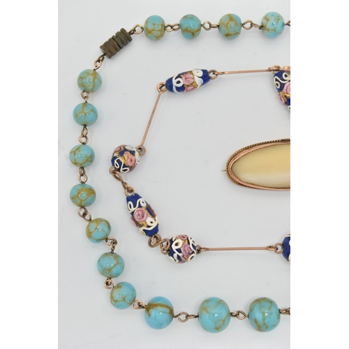 83 - AN EDWARDIAN 9CT YELLOW GOLD MOTHER OF PEARL BROOCH AND TWO BEAD NECKLACES, to include an oval shape... 