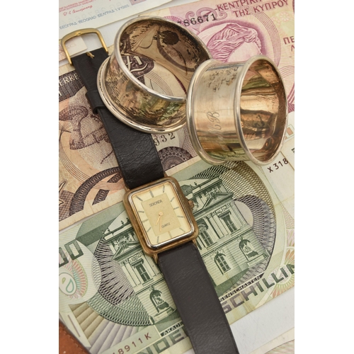 84 - A SELECTION OF FOUR WATCHES, TWO SILVER NAPKIN RINGS AND BANK NOTES, to include a Rotary automatic w... 