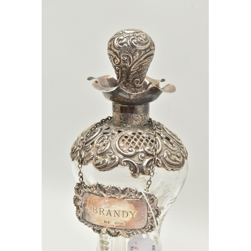 93 - A LATE VICTORIAN GLASS AND SILVER DECANTER, the hour glass bottle with silver collar and stopper emb... 