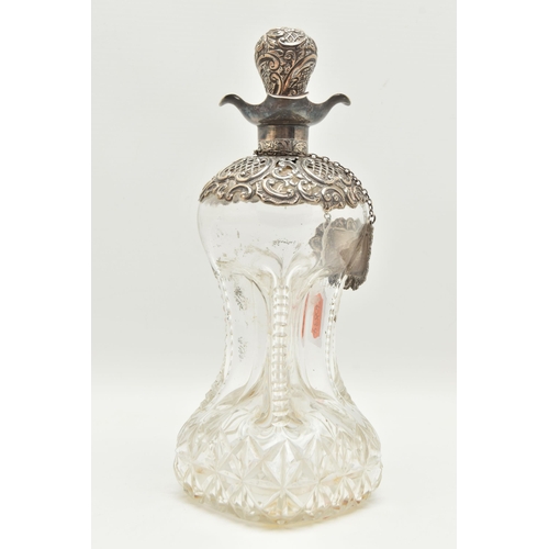 93 - A LATE VICTORIAN GLASS AND SILVER DECANTER, the hour glass bottle with silver collar and stopper emb... 