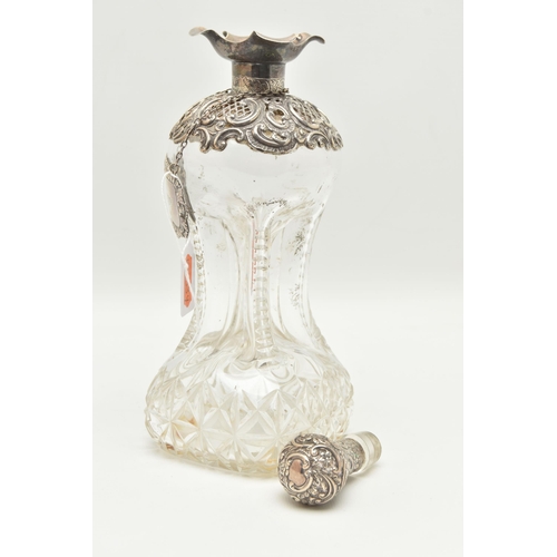 93 - A LATE VICTORIAN GLASS AND SILVER DECANTER, the hour glass bottle with silver collar and stopper emb... 