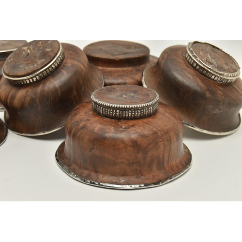 145 - SIX ASSORTED 19TH CENTURY TIBETAN WOODEN BOWLS WITH WHITE METAL LININGS/MOUNTS, largest diameter 12.... 