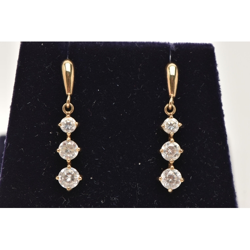 148 - A PAIR OF YELLOW METAL CUBIC ZIRCONIA DROP EARRINGS, designed as a row of three graduated colourless... 