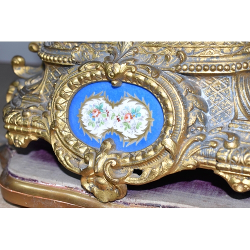 314 - A DECORATIVE FRENCH GILT SPELTER MANTEL CLOCK with hand painted porcelain decorative plaques, with a... 