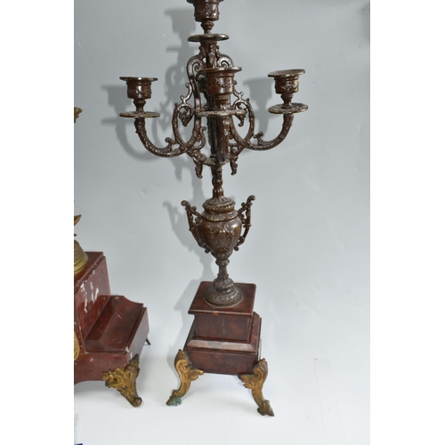 459 - A FRENCH ROUGE MARBLE CLOCK AND SIMILAR STYLE GARNTITURE, clock has a  gilt metal figure of 'Printem... 