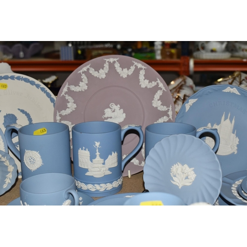 463 - A LARGE COLLECTION OF WEDGWOOD BLUE JASPERWARE, comprising a large sugar bowl (scratches and black m... 