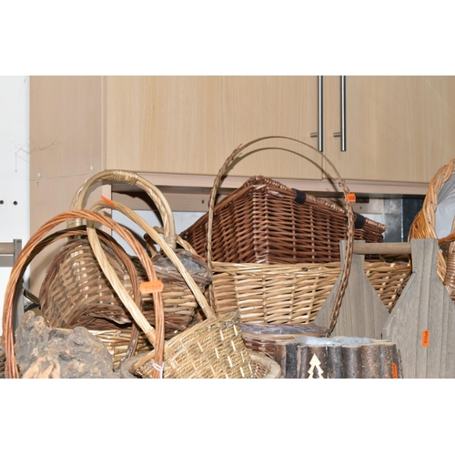 374 - A LARGE QUANTITY OF WICKER BASKETS, comprising wicker flower baskets, a small hamper, a shopping bas... 