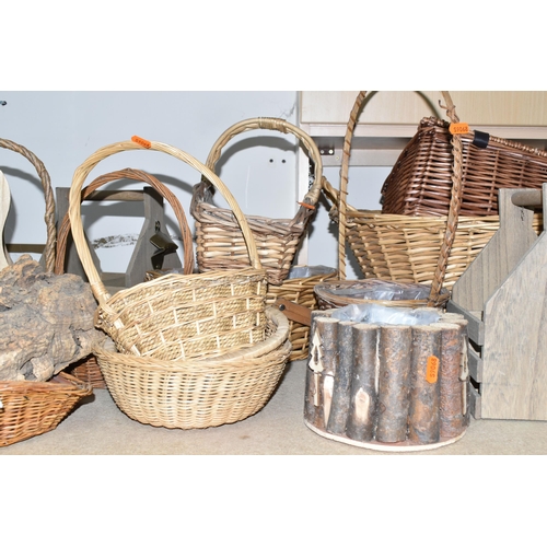 374 - A LARGE QUANTITY OF WICKER BASKETS, comprising wicker flower baskets, a small hamper, a shopping bas... 