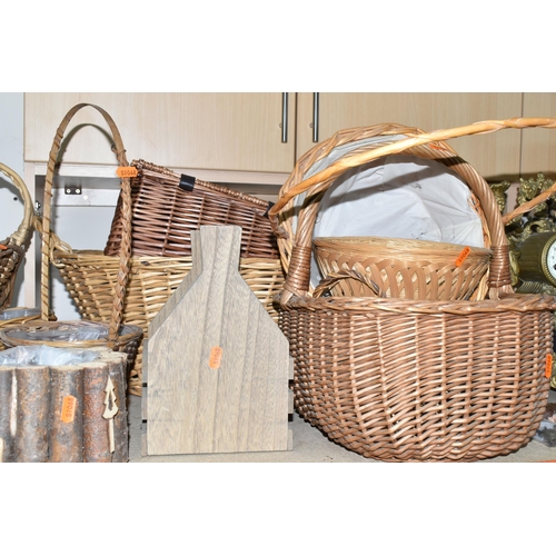 374 - A LARGE QUANTITY OF WICKER BASKETS, comprising wicker flower baskets, a small hamper, a shopping bas... 