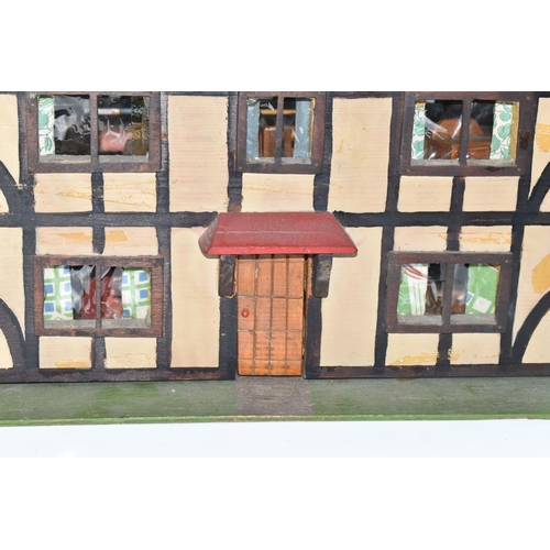 386 - A SCRATCHBUILT SMALL SCALE WOODEN DOLLS HOUSE, c.1950s, modelled as a half-timbered house, front ope... 