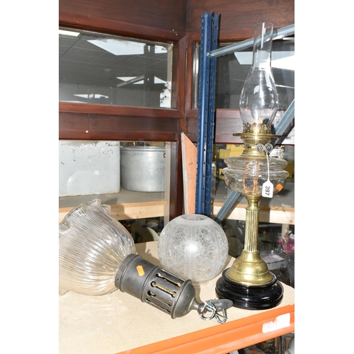 397 - AN OIL LAMP AND CEILING LIGHT FITTING, comprising a brass based oil lamp with glass reservoir, marke... 