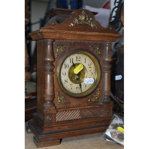 433 - THREE CLOCKS, comprising a large wooden mantel clock with pendulum and key, height 49cm, a smaller m... 